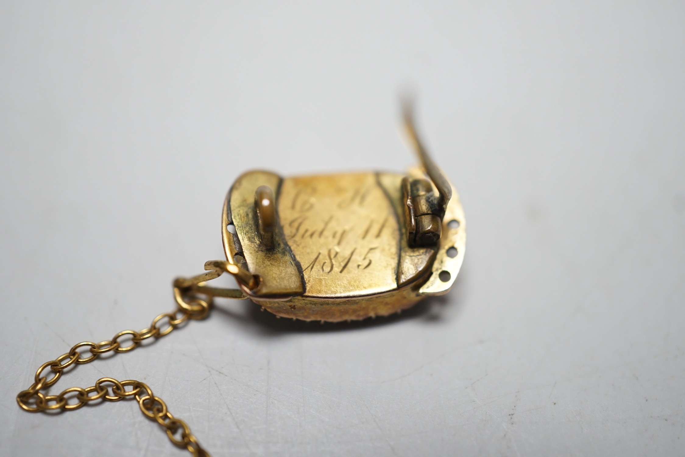 A George III yellow metal and plated hair mourning brooch, engraved 'BH, July 11th, 1815', 16mm, (ex clasp, now mounted as a brooch).